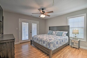A bedroom with a bed, a ceiling fan, a nightstand with a lamp, and a dresser. - Large Home w/ Hot Tub & Pool: 500 ft to the Beach (Murrells Inlet)