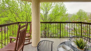 A balcony with a view of green trees and a distant landscape. - Gatlinburg Condo w/ Smoky Views: Walk to Town! (Gatlinburg)