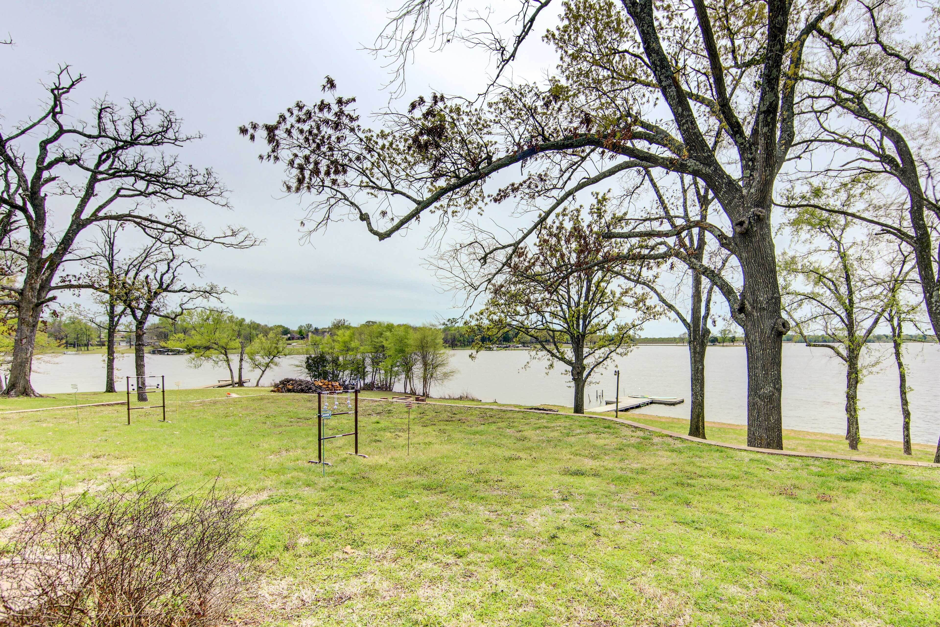 A park with grassy areas, trees, and a body of water.