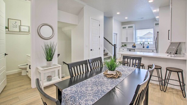 A modern kitchen with white cabinets, a stainless steel refrigerator, and a built-in oven. - Modern Mountain Escape Near Slopes, Lakes & Trails (Eden)