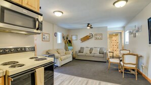 A compact living space with a kitchenette, a sofa, a dining table, and a ceiling fan. - Private Duck Creek Apartment Near Entertainment! (Duck Creek Village)