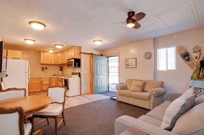 A compact living space with a kitchen, dining area, and seating area.
