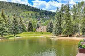 A lake surrounded by trees and houses, with a wooden fence and a bench. - Avon Duplex w/ Hot Tub: Ski Vail & Beaver Creek! (Avon)