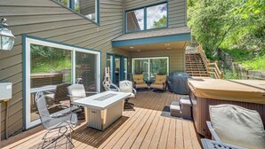 A deck with outdoor furniture, a hot tub, and a staircase leading to a second level. - Avon Duplex w/ Hot Tub: Near Vail Hiking & Golf! (Avon)