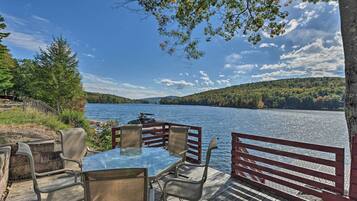 Relax by the serene lake with a clear view of the surrounding greenery from this tranquil lakeside deck.