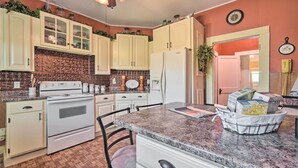 A kitchen with white cabinets, a granite countertop, and a refrigerator. - Historic Sparta Home Near Waterfalls & Hikes! (Sparta)