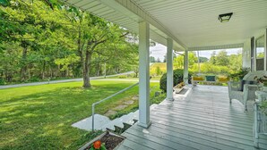 A covered porch with white railings, a bench, and a chair. - Historic Sparta Home Near Waterfalls & Hikes! (Sparta)