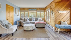 A cozy living room with a sofa set, ottoman, and a bench. - Amazing Rocky Point Retreat Overlooking the Sound! (Rocky Point)