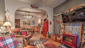 A cozy living room with a fireplace, wooden furniture, and a rustic decor. - Walk to Waterfront: Dtwn Sturgeon Bay Retreat! (Sturgeon Bay)