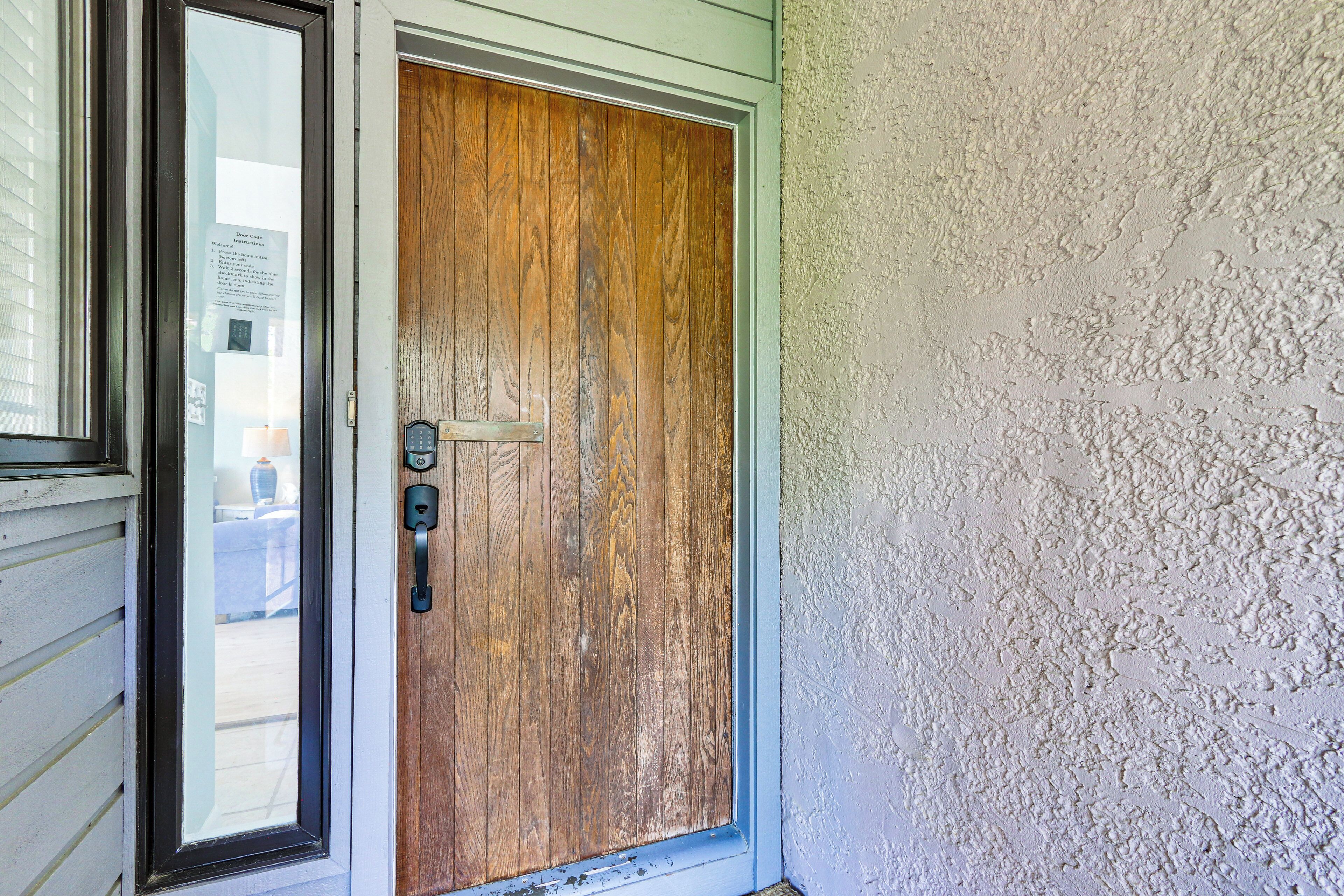 A wooden door with a glass panel and a metal handle.