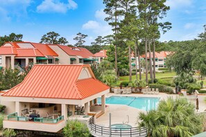 A resort with a swimming pool, outdoor seating, and a view of the surrounding landscape. - 2 Mi to Beach! Hilton Head Golf Escape w/ Balcony (Hilton Head Island)