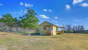 A small yellow house with a porch, surrounded by a fenced yard and trees. - Ranch Cabin w/ Decks, 10 Mi to Fredericksburg (Fredericksburg)