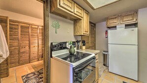 A kitchen with wooden cabinets, a stove, oven, and a refrigerator. - Alto Adventure Base w/ Deck: Hike, Bike & Ski! (Alto)
