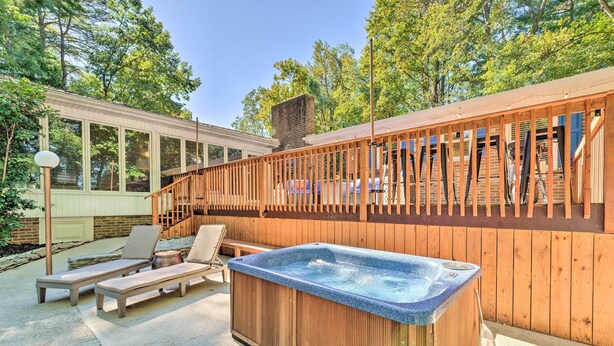 A backyard with a hot tub, lounge chairs, and a wooden deck. - Dobson Getaway w/ Private Pool & Game Room! (Dobson)