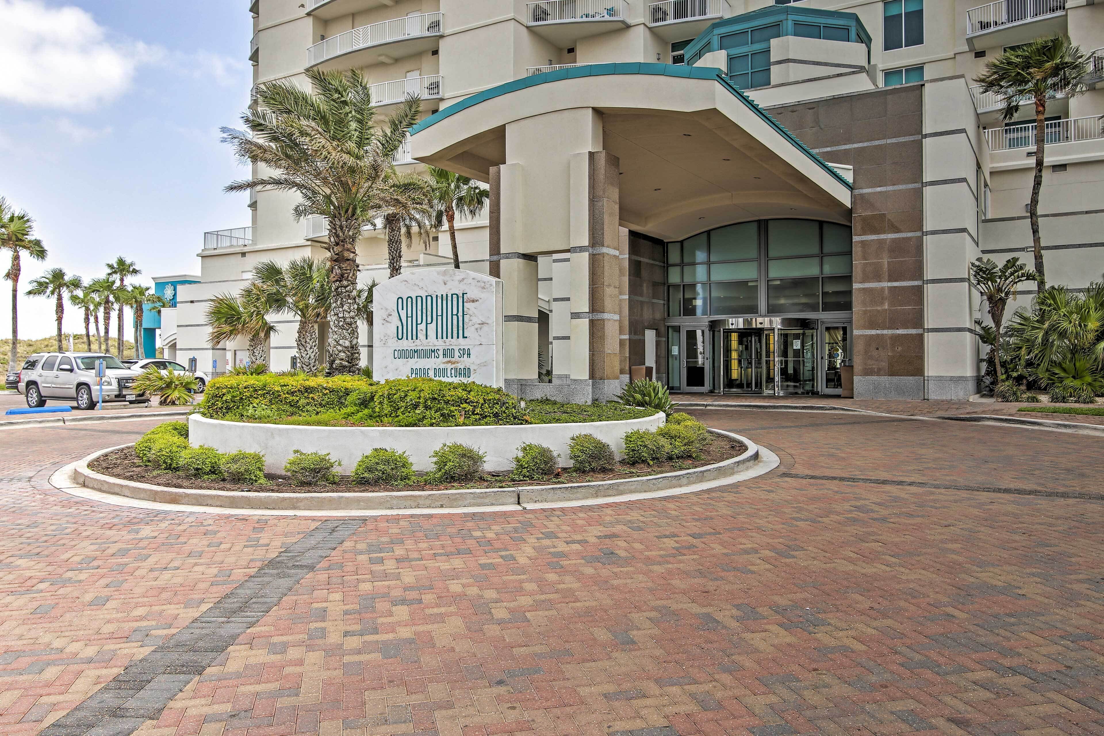 A modern hotel entrance with a sign reading "Sapphire Condominiums and Spa".