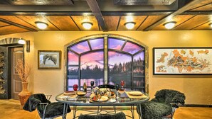 A dining area with a round table, chairs, and a large window with a scenic view. - Willamette Valley Apt - Surrounded by Wineries! (Hillsboro)