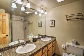 A bathroom with two sinks, a mirror, and a shower. - Cozy Crested Butte Condo - Walk to Ski Lift! (Crested Butte)