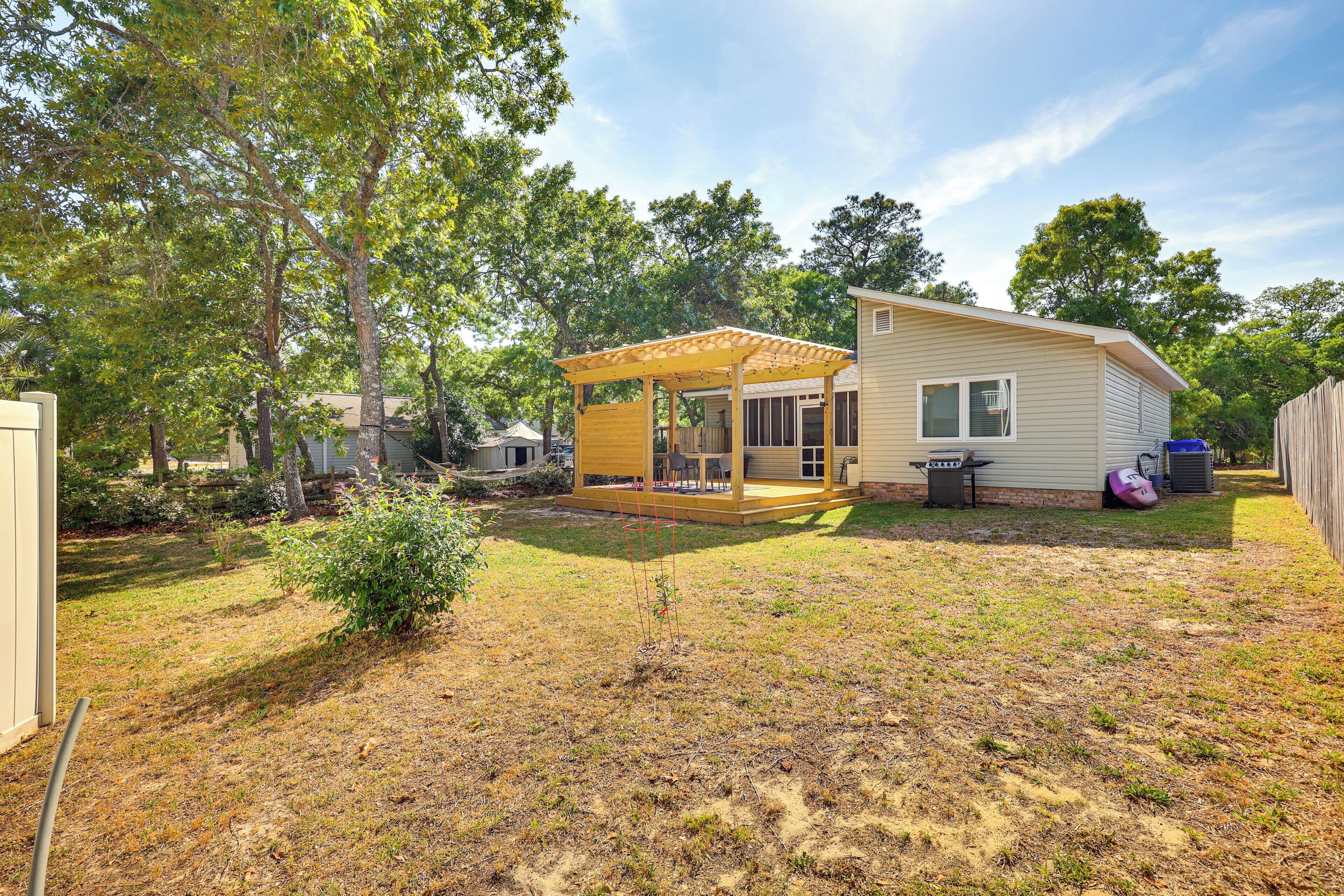 A single-story house with a covered patio and a fenced yard.