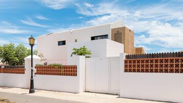 Situated in a quiet street, this building offers a clean, minimalist design with a flat roof and paneling.