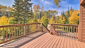 A wooden deck with a railing overlooking a forested area with autumn foliage. - Ski-in/ski-out Cabin: Lift to Brian Head Resort! (Brian Head)