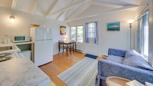 A compact living space with a kitchen, dining area, and seating area. - Couples Getaway Near Beaches: Northport Cottage (Lincolnville)