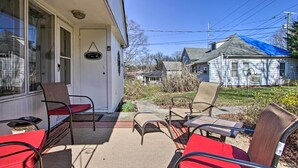 A covered patio with outdoor seating, a white building with a blue roof, and a clear sky. - 2 Mi to Downtown Knoxville: Cozy Home w/ Patio (Knoxville)