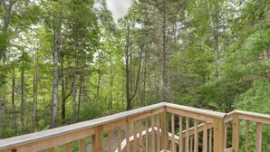 A wooden deck with a view of a dense forest. - Pet-friendly Prospect Apartment: 7 Mi to Beach! (Stockton Springs)