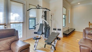 A home gym with exercise equipment, a bench, and a massage table. - Pet-friendly Houston Home ~ 7 Mi to Downtown! (Houston)
