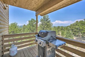 A wooden deck with a barbecue grill and propane tank. - 4 Acres & Mtn Views: Cabin w/ Deck in Florissant (Florissant)