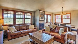A spacious living room with leather sofas, a wooden coffee table, and a fireplace. - Winter Park Retreat: Mtn Views & Pool Access! (Fraser)