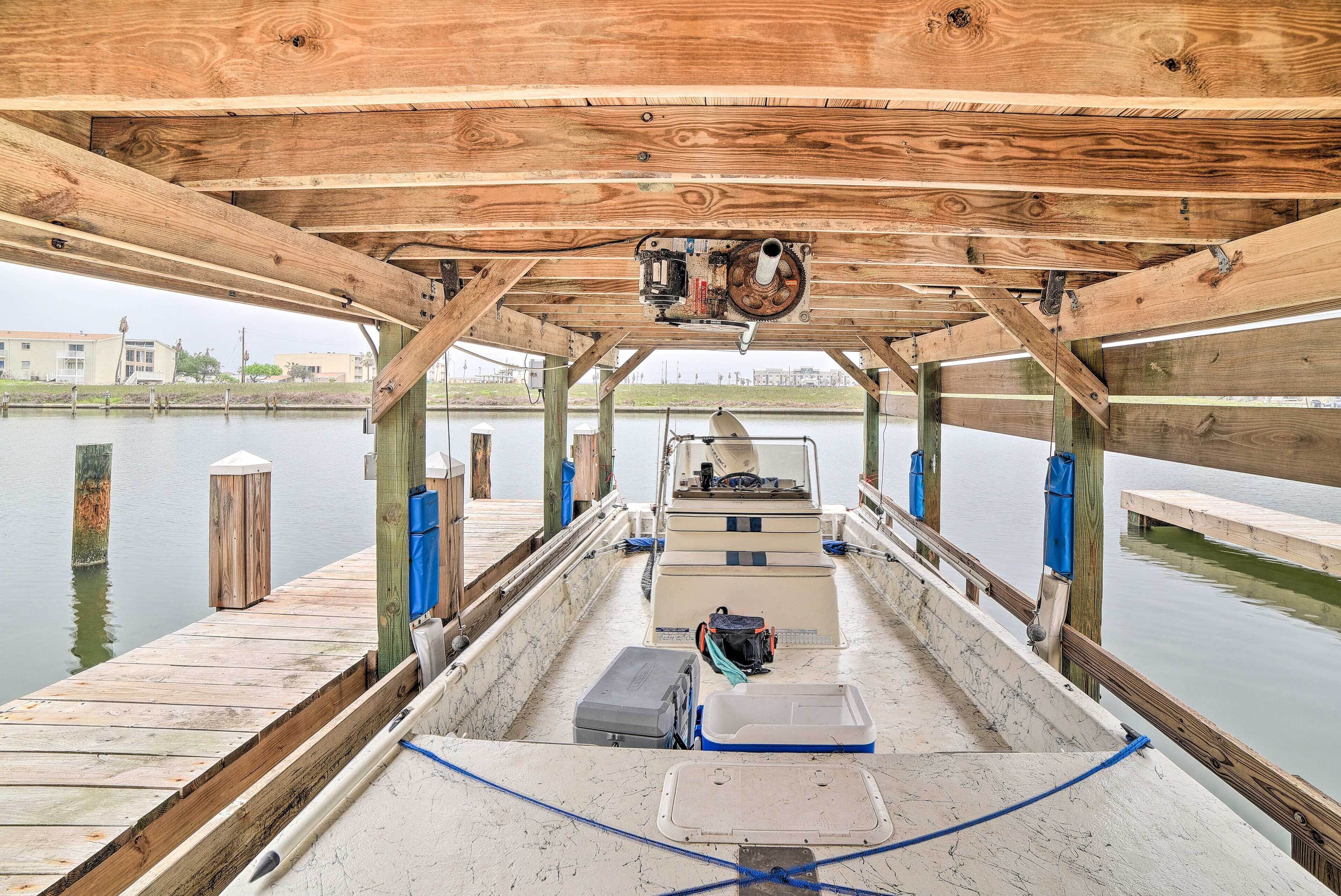 A wooden boat with a cabin, a motor, and a dock.
