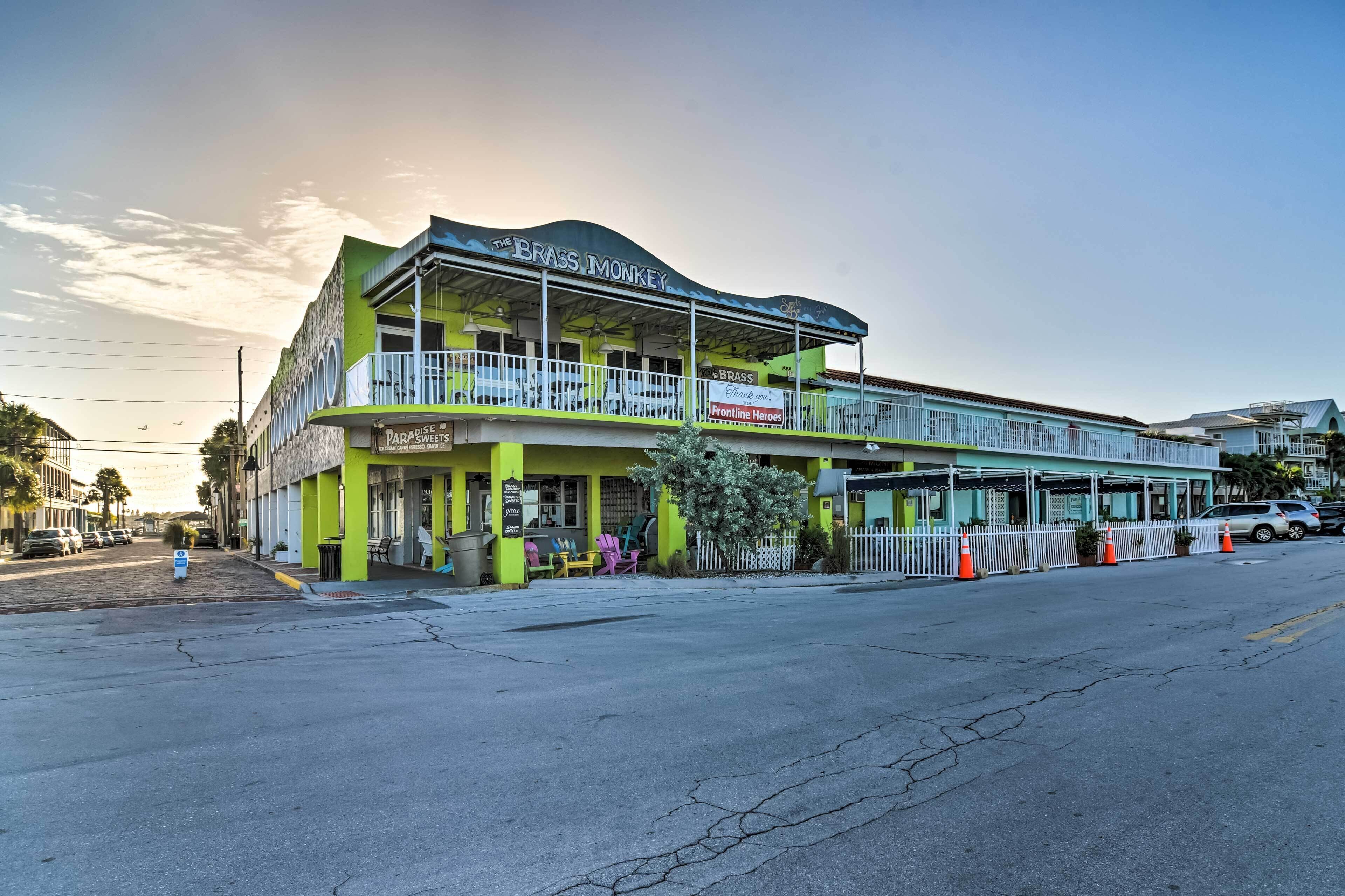A two-story building with a sign reading "The Brass Monkey Paradise Frontline Heroes."