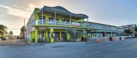 A two-story building with a sign reading "The Brass Monkey Paradise Frontline Heroes."