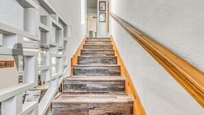 A wooden staircase with white walls and a wooden handrail. - Cozy Ruidoso Condo w/ Deck ~ 2 Mi to Cedar Creek! (Ruidoso)