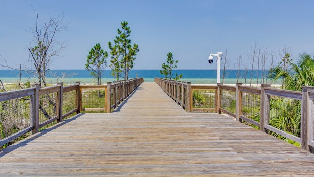 A wooden boardwalk leading to a beach with clear skies. - Coastal Port St Joe Getaway w/ Pool & Beach Access (Port St. Joe)