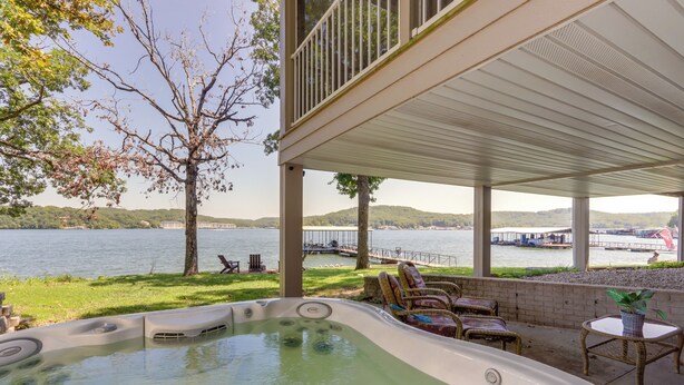 A hot tub area with a view of a lake, outdoor furniture, and a covered patio. - Dock, Hot Tub! Family-friendly Camdenton Haven (Camdenton)