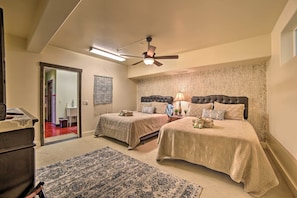 A bedroom with two beds, a ceiling fan, and a large rug. - Moab Getaway w/ Ample Parking, Walk to Main Street (Moab)