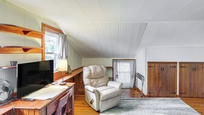 A room with a wooden desk, a chair, a television, and a window with curtains. - Central & Private Milan Home ~ 10 Mi to Sandusky! (Milan)