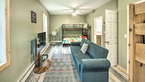 A compact room with a bunk bed, a sofa, a TV, and a ceiling fan. - Secluded New Durham Home w/ Mtn & Lake Views! (New Durham)