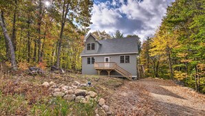 A two-story house with a wooden deck and a staircase leading to the second floor. - Secluded New Durham Home w/ Mtn & Lake Views! (New Durham)