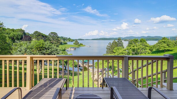 A wooden deck with a view of a lake and surrounding greenery. - Rutledge Hilltop Home on Cherokee Lake w/ Decks! (Rutledge)
