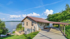 A house with a porch overlooking a lake, a dock, and a boat. - Rutledge Hilltop Home on Cherokee Lake w/ Decks! (Rutledge)