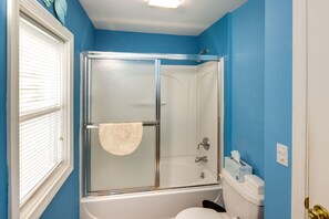 A bathroom with a glass-enclosed shower, a white bathtub, and a toilet. - Charming Old Saybrook Home: Half-mi to Sand & Sea! (Old Saybrook)