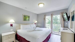 A bedroom with a bed, bedside tables, a dresser, a window with curtains, and a balcony. - Kissimmee Escape ~ 10 Mi to Disney World! (Kissimmee)
