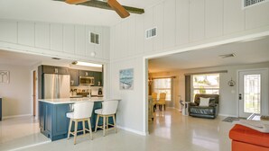 A spacious living area with a kitchen, a dining area, and a seating area with a sofa and chairs. - Canalfront Home w/ Dock & Pool: 5 Mi to Ft Myers! (North Fort Myers)