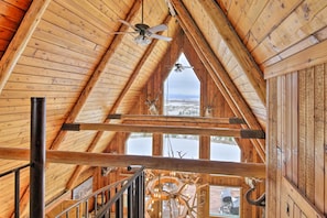A high-ceilinged wooden interior with a view of a snowy landscape.