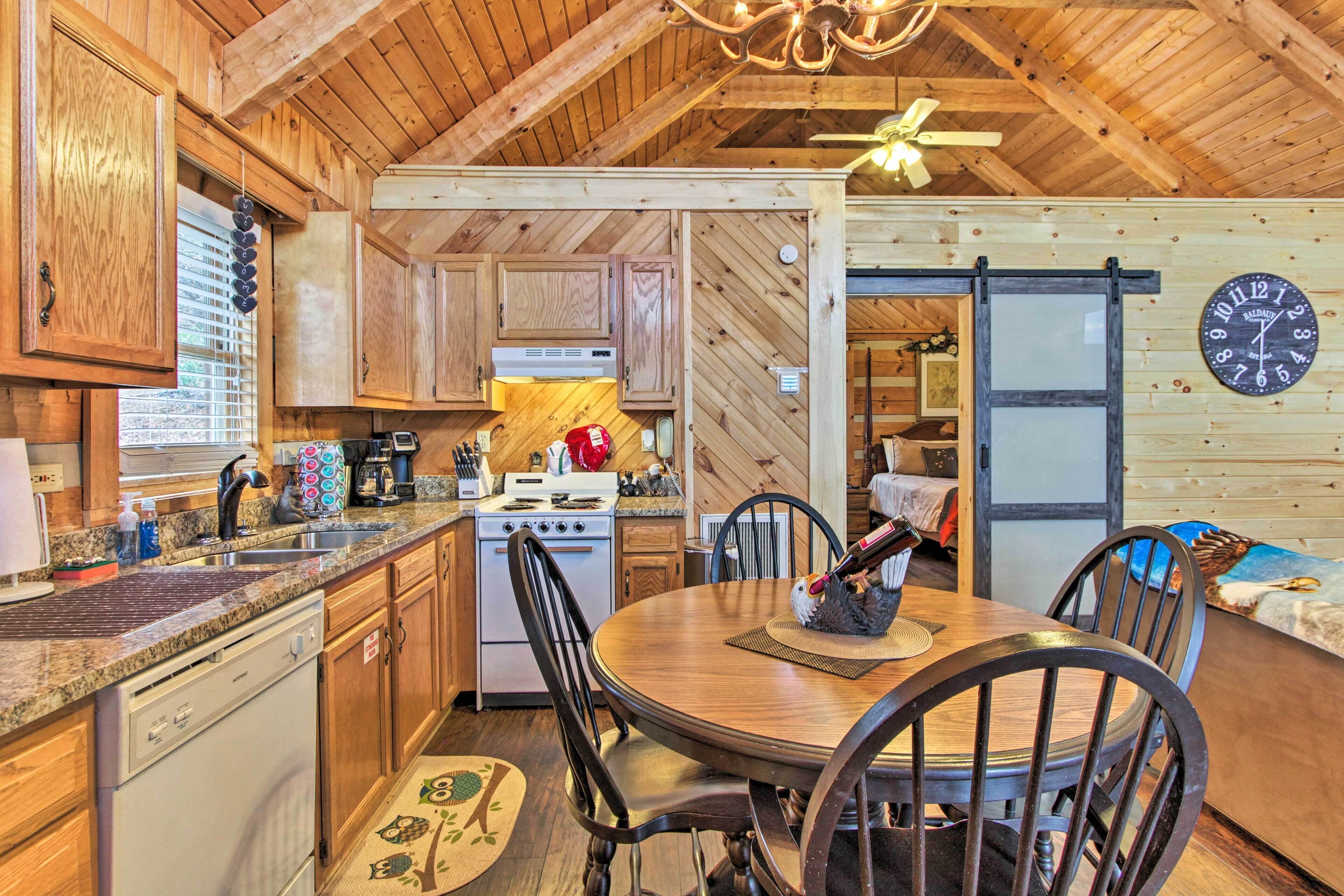 A wooden interior with a kitchen, dining area, and a clock on the wall.