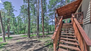 A wooden staircase leading to a cabin in a forested area. - Pet-friendly Ruidoso Home w/ Deck & Forest Views! (Ruidoso)