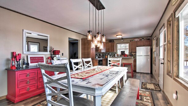 Une cuisine avec une table à manger, des chaises et un buffet rouge.