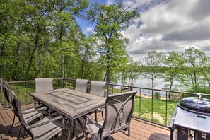 A deck with a table and chairs, overlooking a lake. - Stunning Crosslake Cabin w/ Deck and Lake Views! (Crosslake)